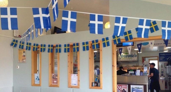 In recogntion of their shared Nordic heritage, a Shetland restaurant is decorated with Shetland and Swedish flags on the latter's national day..jpg